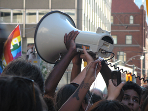Hands holding up a megaphone
